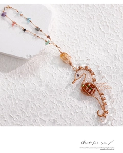 Detailed view of handmade seahorse pendant with wire-wrapped colorful natural gemstones