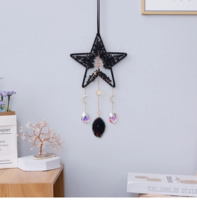 Detail of tree of life star suncatcher with black stones, crystals and agate slice