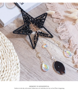 Detail of star-shaped Tree of Life suncatcher with black obsidian and hanging agate slice