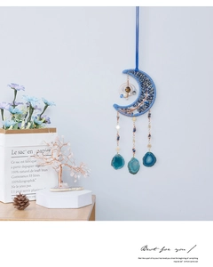 Detail of moon-shaped woven hanger with lapis chips and green agate stone slices