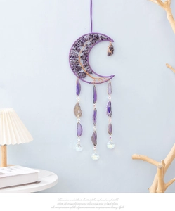 Detail of crescent moon suncatcher with purple agate slices and crystal prisms