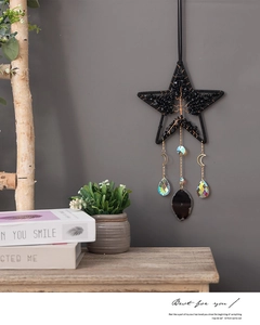 Detailed view of Tree of Life suncatcher featuring crystals and a black star frame