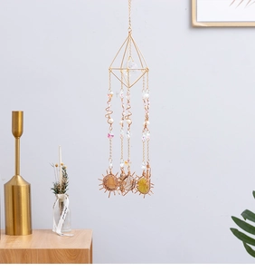 Detail of geometric gold suncatcher with natural agate slices and crystal beads