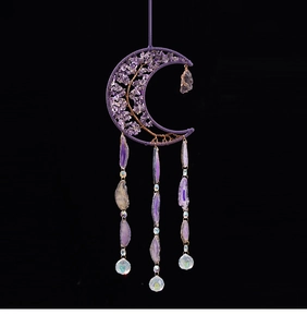 Detailed view of crescent moon suncatcher with purple crystals and agate slices
