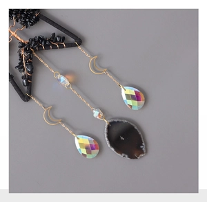 Detail of life tree suncatcher with black stone, golden moon charm and crystal drop