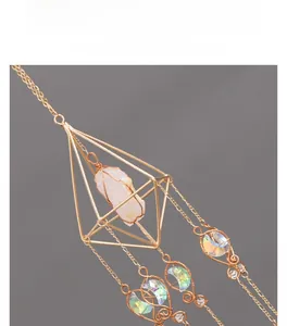 Detail of handmade wire-wrapped octahedron suncatcher with white stone and moon crystals