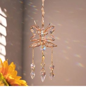Detail of wire-wrapped butterfly suncatcher with crystal prisms and rainbow reflections