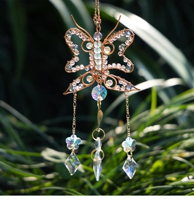 Detail of handmade wire-wrapped butterfly suncatcher with crystal prisms and beads