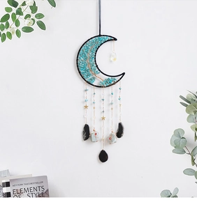 Detail of moon-shaped tree of life suncatcher with turquoise stones and crystal fringe