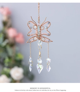 Macro detail of wire-wrapped butterfly suncatcher with colorful beads and crystal pendants