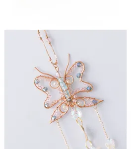 Detailed handmade wire-wrapped butterfly suncatcher with beads and gold fringe chains