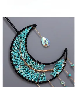 Detail of tree of life moon suncatcher with turquoise stones and crystal pendants