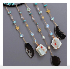 Detail of tree of life suncatcher with turquoise stones and celestial metal charms