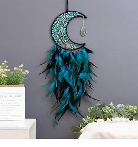 Detail of turquoise tree of life dreamcatcher with crescent moon and gradient feathers