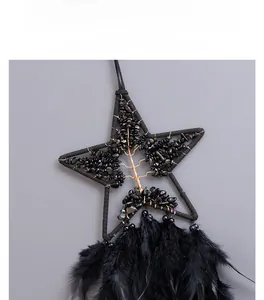 Detail of star-shaped dream catcher with black crystal tree of life and feathers