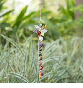 Detail of handmade seven chakra natural crystal stones woven in a lotus hanging ornament