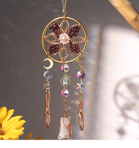 Detail of dreamcatcher suncatcher with raw crystal and rainbow light reflections