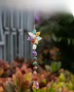 Detailed view of handmade seven chakra hanging decor with raw crystals and star design