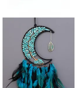 Macro detail of moon-shaped dreamcatcher with turquoise tree of life and gradient feathers
