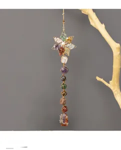 Detailed view of handmade seven chakra hanging decor with raw natural stones and lotus charm