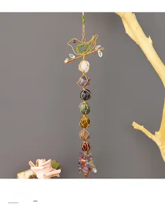 Detailed view of handmade bird chakra pendant with seven natural irregular crystal stones