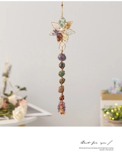 Macro detail of hand-woven 7 chakra raw stone wall hanging with wire wrapped star