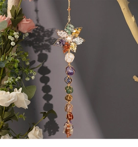 Detail of handmade 7 chakra healing crystal hanging ornament with natural wire wrapped stones
