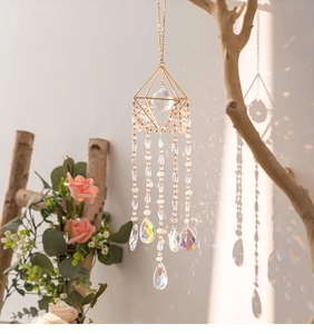 Detailed close-up of a geometric crystal suncatcher reflecting rainbow light on a wall