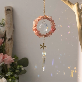 Hanging crystal suncatcher with pink crushed stones and faceted prism for rainbow light