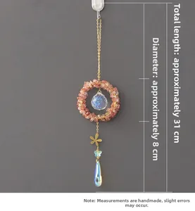 Close-up of watermelon crystal suncatcher with golden chains and crystal prism detail