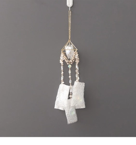 Detailed view of suncatcher hanging with golden geometric frames and pink beads