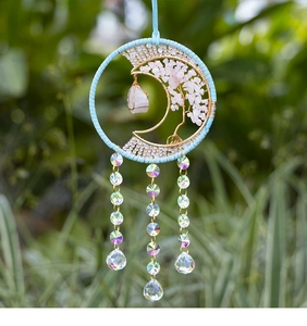 Detailed view of Tree of Life suncatcher with pink quartz stones and crystal prism drops