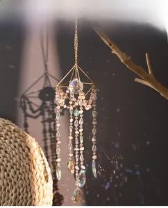 Close-up of geometric sun catcher with pink crystal beads and rainbow prism reflection