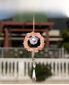 Detail of suncatcher with watermelon crystal chips, gold butterfly and crystal prism ball