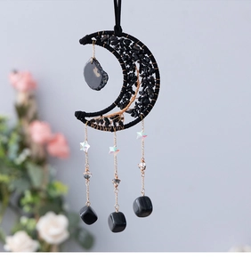 Detailed view of Tree of Life moon catcher with black healing crystals and gold chains