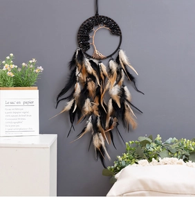 Detailed view of Tree of Life dreamcatcher with black beads and natural feathers