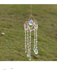 Macro detail of suncatcher featuring gold geometric frame and rainbow crystal pendants