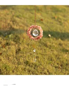 Detail of pink crystal suncatcher with golden chain and faceted crystal drop pendant