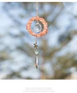 Detail view of crystal suncatcher with natural stones and iridescent water drop prism