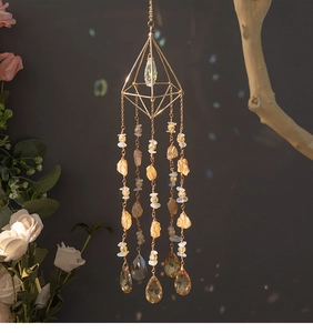 Macro shot of geometric sun catcher with raw citrine stones and amber crystal teardrops