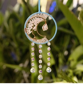 Detailed view of Tree of Life suncatcher with pink crystals and clear faceted pendants