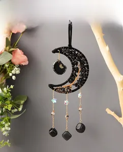 Detail of life tree moon dreamcatcher with black stones and hanging crystal pendants