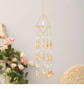 Detailed view of citrine suncatcher with golden geometric frame and amber raw stones