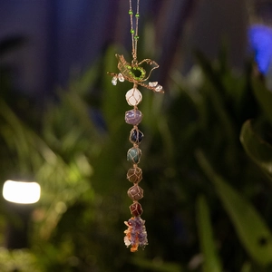 Handcrafted seven chakra crystal bird ornament with irregular raw stones in nature