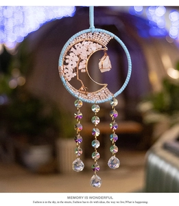 Detail of life tree moon dreamcatcher with pink quartz stones and crystal prisms