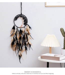 Detail of tree of life dreamcatcher with black feathers and bronze wire weaving decoration