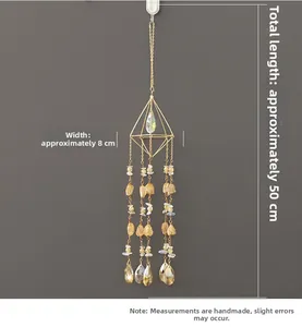 Macro detail of suncatcher showing golden geometric frame and yellow crystal stones