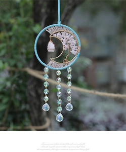 Macro view of crystal tree of life suncatcher hanging on a tree in a sunny garden