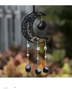 Detail of moon shaped tree of life suncatcher with black crystals for garden decor