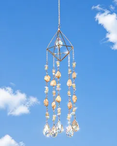 Macro view of geometric gold frame with citrine stones and faceted crystal teardrop charms
